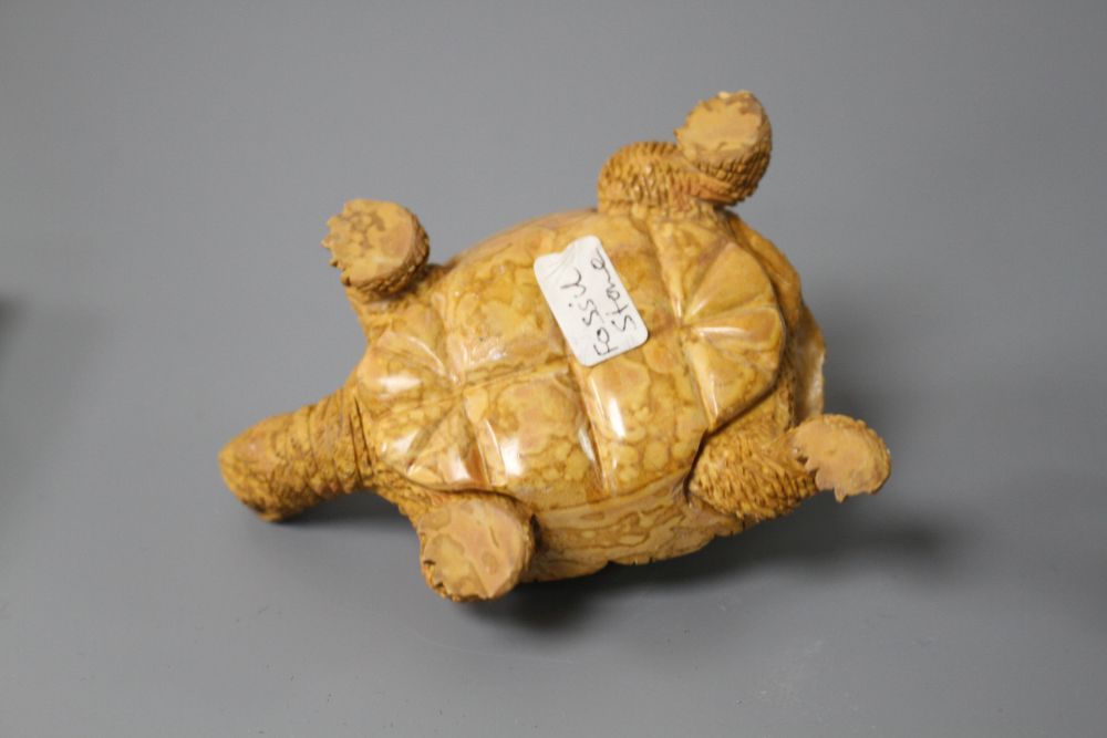 A carved fossil stone tortoise, 8cm and a carved Rhiolite carving of a frog, 4cm